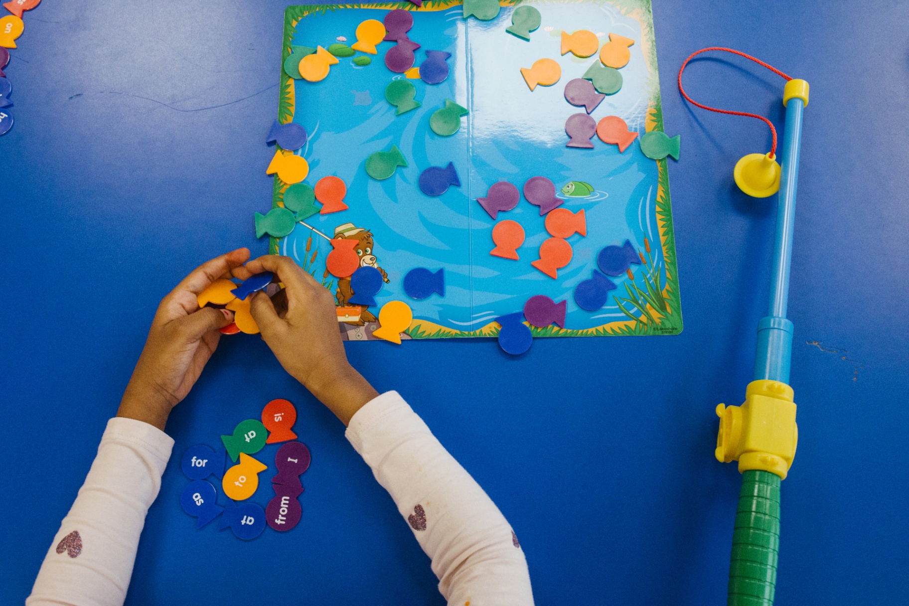 Highland Academy student using colorful hands-on learning materials